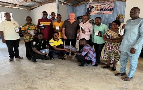 Group of believers proudly holding their new Bibles