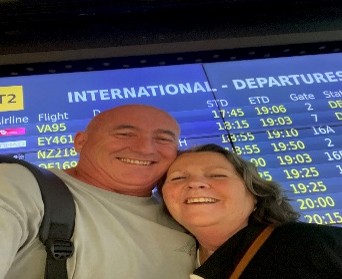 Took a selfie at an international airport departures area, preparing for their mission trip to Ghana.