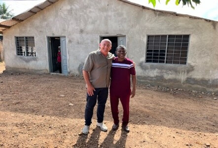 Photo of me and Samuel outside a residential house